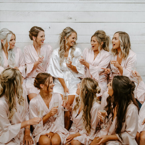 Bridal party in robes toasting