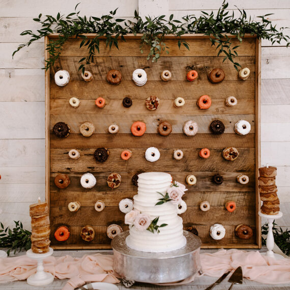 Donut wall and wedding cake dessert display